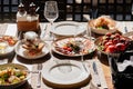 wooden table served with plates with salad and snacks on the open terrace Royalty Free Stock Photo