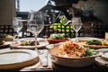 wooden table served with plates with salad and snacks on the open terrace Royalty Free Stock Photo