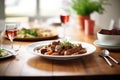a wooden table set with beef bourguignon for dinner Royalty Free Stock Photo