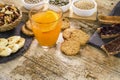 Wooden table set for a sweet vegan breakfast with orange juice, sliced banana, mixed dried fruit, vegan biscuits, slices of bread Royalty Free Stock Photo