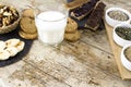 Wooden table set for a sweet vegan breakfast with rice drink, sliced banana, mixed dried fruit, vegan biscuits, slices of bread Royalty Free Stock Photo