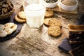 Wooden table set for a sweet vegan breakfast with rice drink, sliced banana, mixed dried fruit, vegan biscuits, slices of bread Royalty Free Stock Photo