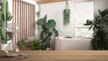 Wooden table or shelf with crystal hourglass measuring the passing time over modern bathroom with houseplants, urban jungle