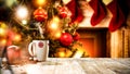 A wooden table with space for your advertising products. Blurred great green Christmas tree and Fireplace with flames and red sock