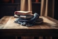 a wooden table with a stack of books and a beautiful napkin in the middle