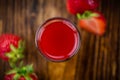 Wooden table with Strawberry liqueur, selective focus Royalty Free Stock Photo