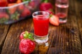 Wooden table with Strawberry liqueur, selective focus Royalty Free Stock Photo