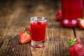 Wooden table with Strawberry liqueur, selective focus Royalty Free Stock Photo