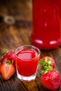 Wooden table with Strawberry liqueur, selective focus Royalty Free Stock Photo