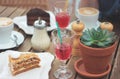 Wooden table on summer terrace with cake, berry juice, succulent