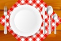 Wooden table, cloth, plate and stainless cutlery Royalty Free Stock Photo