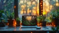 Wooden table with tablet computer and flowers in pots