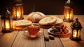 Wooden table with tea, dates, bread, and lanterns in warm lighting Royalty Free Stock Photo