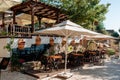 Wooden table on the terrace under an umbrella in the open air city of Side Turkey. Beautiful Furniture near the old wall on the Royalty Free Stock Photo