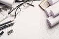 On the wooden table there are drawings, compasses, pencil, elastic, ruler, sharpener and glasses. Royalty Free Stock Photo