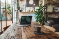 A laptop is placed on the table next to a coffee cup Royalty Free Stock Photo