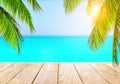 Wooden table top on blue sea and white sand beach