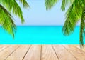 Wooden table top on blue sea and white sand beach Royalty Free Stock Photo