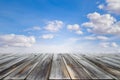 Wooden table top with blue sky and white clouds. Space for present a product Royalty Free Stock Photo