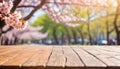 Wooden table top with blur background of Pink Cherry blossom flowers. Generative AI Royalty Free Stock Photo