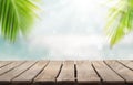 Wooden table top on blur blue sea and coconut leaf background in summer season.For place food,drink or health care business.fresh