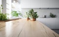 wooden table top and blur bokeh modern kitchen interior with window and plants Royalty Free Stock Photo