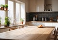 Wooden table top on blur kitchen room with window in background. Advertising template for utensil and products. Copy Royalty Free Stock Photo