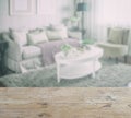 Wooden table top with blur of living room interior Royalty Free Stock Photo