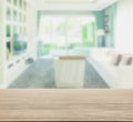 Wooden table top with blur of living room in modern classic style Royalty Free Stock Photo