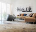 Wooden table top with blur of modern living room interior Royalty Free Stock Photo