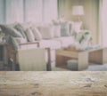 Wooden table top with blur of modern living room interior Royalty Free Stock Photo