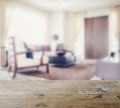 Wooden table top with blur of modern living room interior Royalty Free Stock Photo