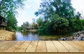 Wooden table top on blur stream water and forest natural background in private resort.For montage product display or design key