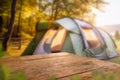 Wooden table top on blur tent camping travel tent and grass field.Fresh and Relax concept.For montage product display or design