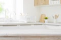 Wooden table top on blurred modern kitchen sink interior background Royalty Free Stock Photo