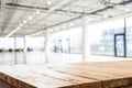 Wooden table top with blurred office interior Royalty Free Stock Photo
