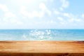 Wooden table top on blurred summer blue sea and sky background. Copy space for your display or montage product design Royalty Free Stock Photo