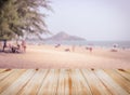 Wooden table top with blurred tropical sea beach