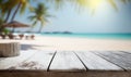 a wooden table top with a blurry beach in the background