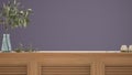 Wooden table top, cabinet, panel or shelf with shutters close up. Olive branch in glass vase, leaves and candles. Purple wall