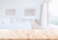Wooden table top in front of blurred bedroom interior background. for montage or display your products