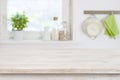 Wooden table top in front of blurred kitchen interior background Royalty Free Stock Photo