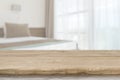 Wooden table top in front of defocused bedroom interior background Royalty Free Stock Photo