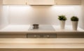 Wooden table top on kitchen island in modern simple home interior.