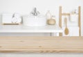 Wooden table top over blurred bathroom interior as the background Royalty Free Stock Photo