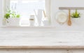 Wooden table top over blurred kitchen interior with copy space Royalty Free Stock Photo