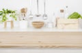 Wooden table top over blurred kitchen utensils for product display Royalty Free Stock Photo