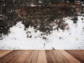 Wooden table top over dirty old wall