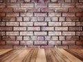 Wooden table top over vintage brick wall texture and background Royalty Free Stock Photo
