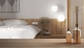Wooden table top or shelf with aromatic sticks bottles over modern bedroom in japanese style, double wooden bed with pillows and